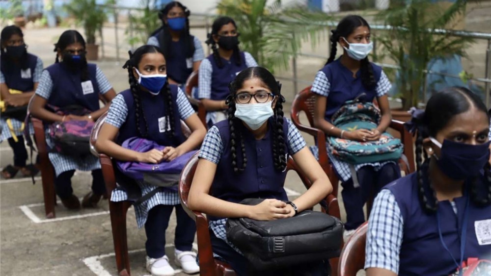 Students arrive at school to get study materials for the lockdown period, July 17, 2020 , IANS