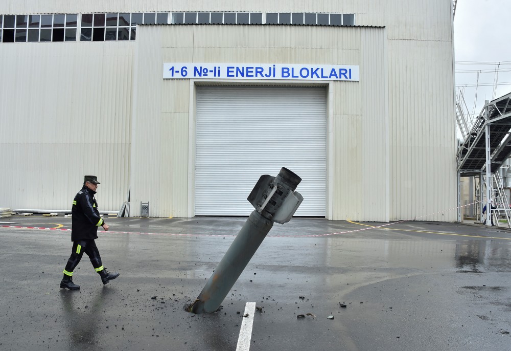 A sapper works next to an unexploded BM-30 Smerch rocket allegedly fired by Armenian forces in the fighting over the breakaway region of Nagorno-Karabakh, near the Mingachevir Hydro Power Station in the town of Mingachevir, Azerbaijan October 5, 2020. REUTERS/Stringer