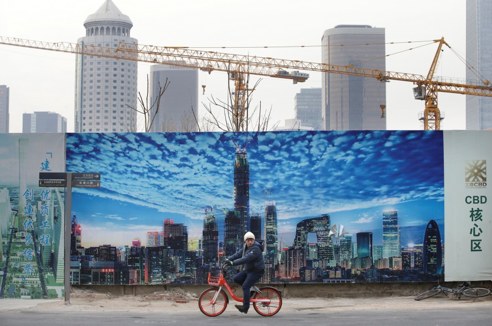 A man cycles outside the construction sites in Beijing's central business area, China January 18, 2019. REUTERS/Jason Lee/Files