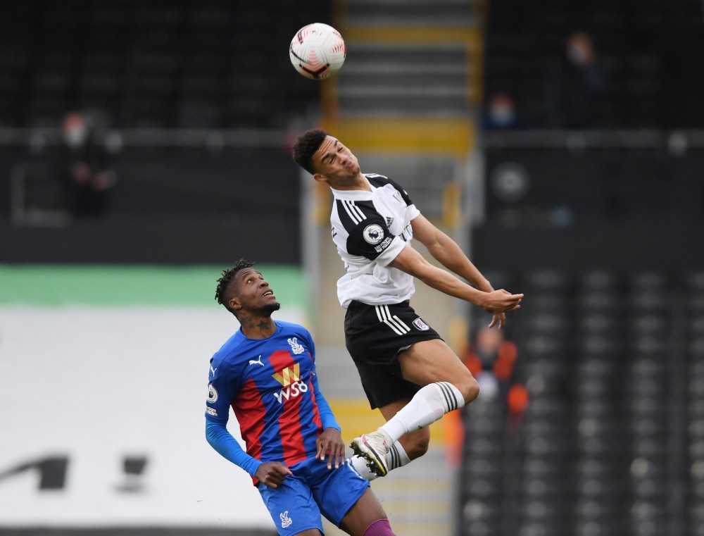 Soccer Football - Premier League - Fulham v Crystal Palace - Craven Cottage, London, Britain - October 24, 2020 Fulham's Antonee Robinson in action with Crystal Palace's Wilfried Zaha Pool via REUTERS/Mike Hewitt