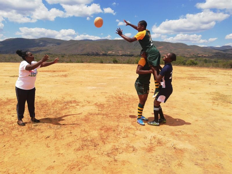 Sahumani Secondary rugby team coach Patricia-Mukunike-Chakanya is throwing the ball at Cathrine Muranganwa lifted by Trish Kandemiri and Velme Nyarumwe during a line-out at Sahumani Secondary, Honde Valley on September 11 2020. (Thomson Reuters Foundation File Photo)