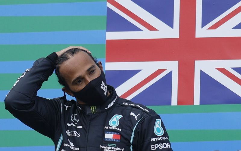 Mercedes' Lewis Hamilton celebrates on the podium after winning the race Pool via REUTERS/Ronald Wittek