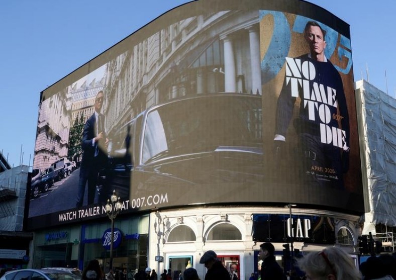 FILE PHOTO: A film trailer for the 25th instalment in the James Bond series entitled "No Time to Die" is displayed at Piccadilly Circus in London, December 4, 2019. REUTERS/Lisi Niesner