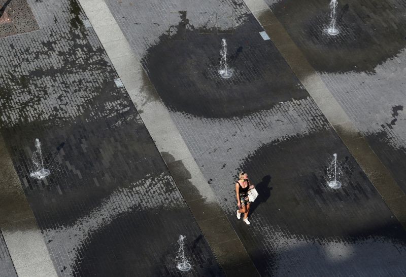 A woman walks among fountains on a square in central city during a hot summer day in Brussels, Belgium on September 16, 2020. (REUTERS File Photo)