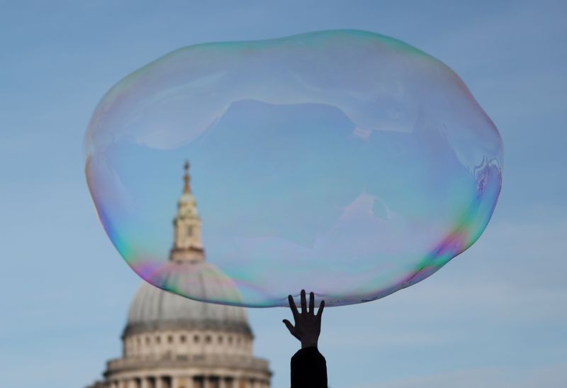 A child bursts a soap bubble as it floats past St Paul's Cathedral in London, Britain, December 27, 2019. (REUTERS File Photo)