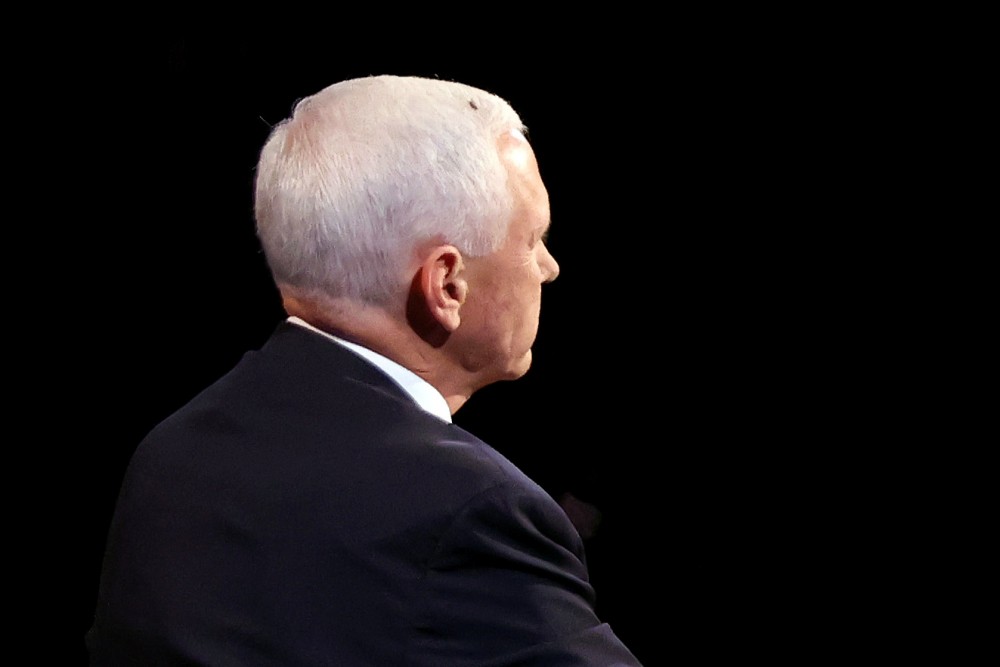 A fly is seen on the head of U.S. Vice President Mike Pence as he takes part in the 2020 vice presidential debate with the Democratic vice presidential nominee and U.S. Senator Kamala Harris (not pictured) on the campus of the University of Utah in Salt Lake City, Utah, U.S., October 7, 2020. Justin Sullivan/Pool via REUTERS