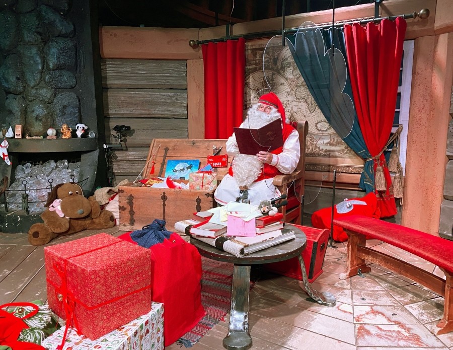 Santa Claus is pictured in his chamber behind a plexiglas screen at Santa Claus Village in the Arctic Circle near Rovaniemi, Finland October 13, 2020. REUTERS/Attila Cser