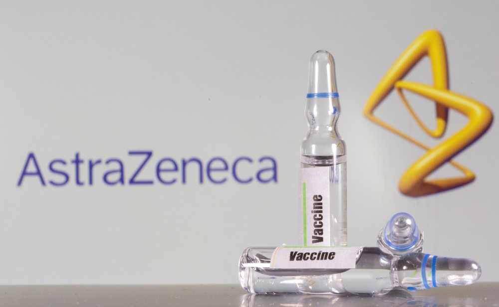 FILE PHOTO: A test tube labeled with the vaccine is seen in front of AstraZeneca logo in this illustration taken, September 9, 2020. REUTERS/Dado Ruvic/File Photo