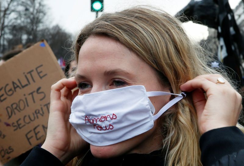 A woman wears a protective face mask that reads: "Love each other" during a protest demanding equality on International Women's Day in Paris, France March 8, 2020. (REUTERS File Photo)