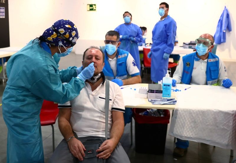 A man has a swab sample taken for a coronavirus disease (COVID-19) antigen test at a cultural centre in the working class neighbourhood of Vallecas in Madrid, Spain on October 1, 2020. (REUTERS Photo)