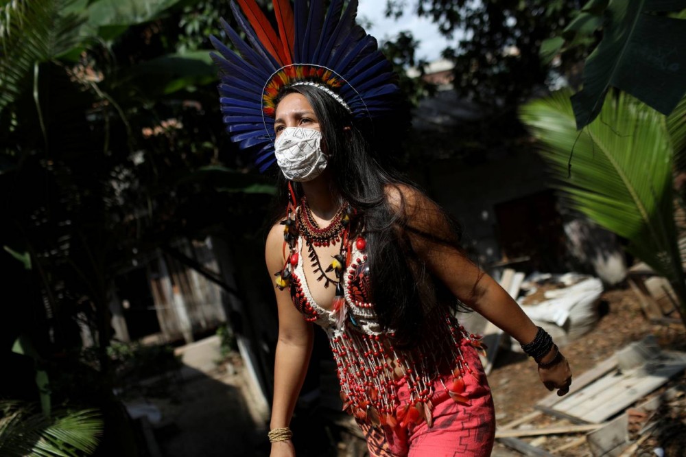 Samela Satere-Mawe, a 24-year-old biology student and Indigenous activist walks near her home, which is also the headquarters of the Satere Mawe WomenÕs Association in the Compensa neighborhood in Manaus, Amazonas state, Brazil, October 2, 2020. REUTERS/Bruno Kelly