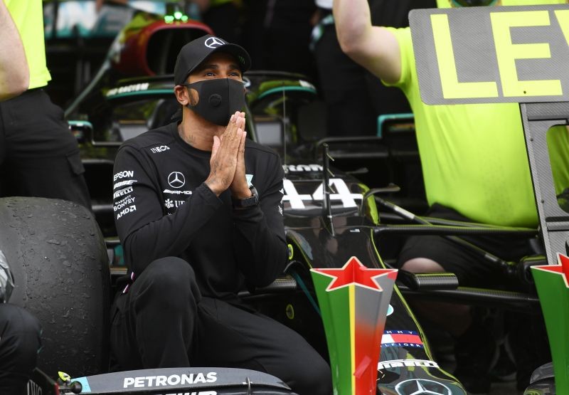 Mercedes' Lewis Hamilton celebrates winning the race with his team Pool via REUTERS/Rudy Carezzevoli