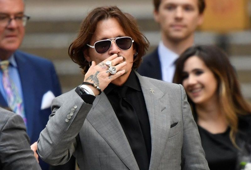FILE PHOTO: Actor Johnny Depp gestures as he leaves the High Court in London, Britain July 28, 2020. REUTERS/Toby Melville