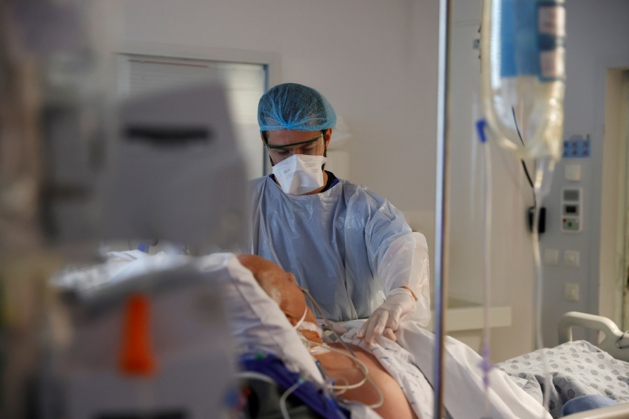 A doctor, wearing a protective mask and a protective suit, works in the Intensive Care Unit (ICU) where patients suffering from the coronavirus disease (COVID-19) are treated at the Bethune-Beuvry hospital in Beuvry, France, October 16, 2020. REUTERS/Pascal Rossignol