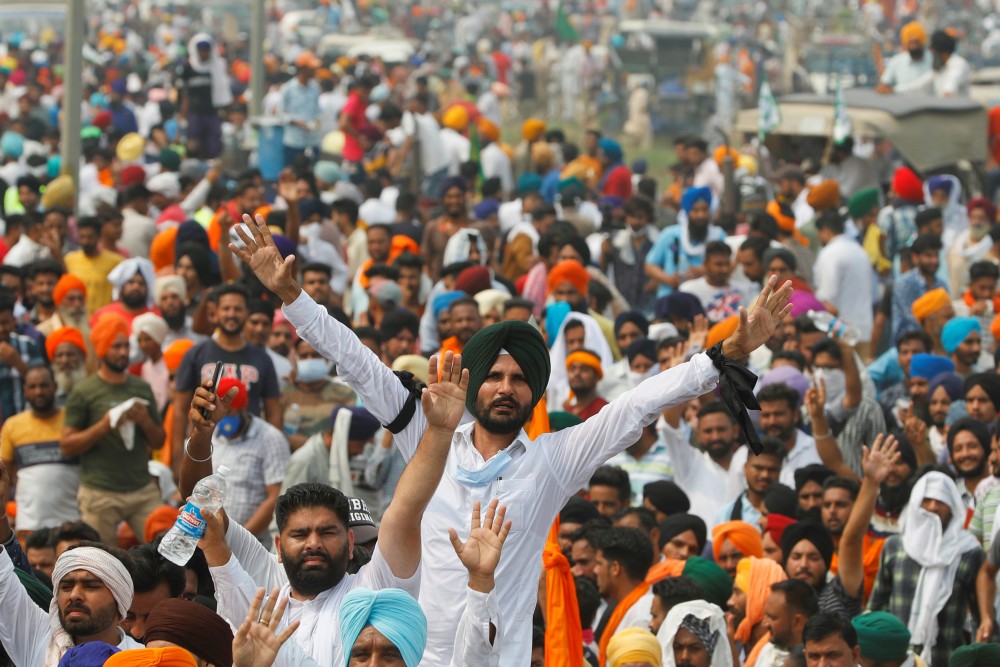 Farmers sit on the water tank as they block a national highway during a protest against farm bills passed by India's parliament, in Shambhu in Punjab, India, September 25, 2020. REUTERS/Adnan Abidi