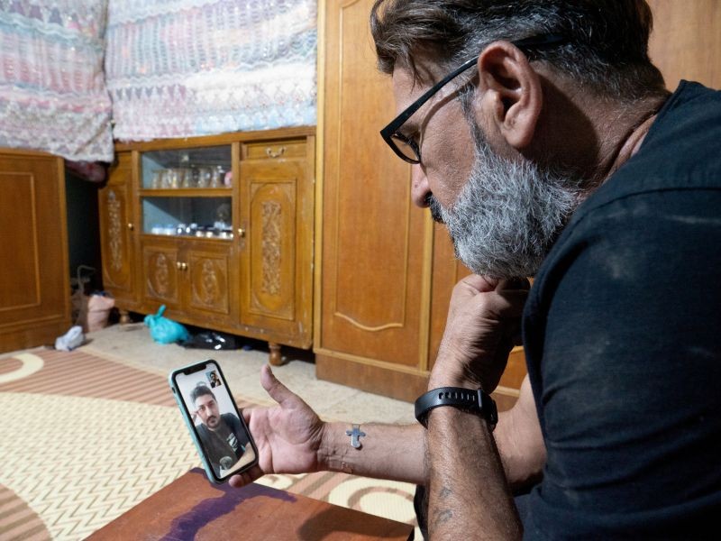 Mohammed al-Dahamat, brother of late civil society activist, Amjad al-Dahamat, speaks on the phone to Hasanain Alminshid, who fled Amarah after receiving threats for participating in anti-government protests, in Amarah, Iraq October 12, 2020. (REUTERS File Photo)