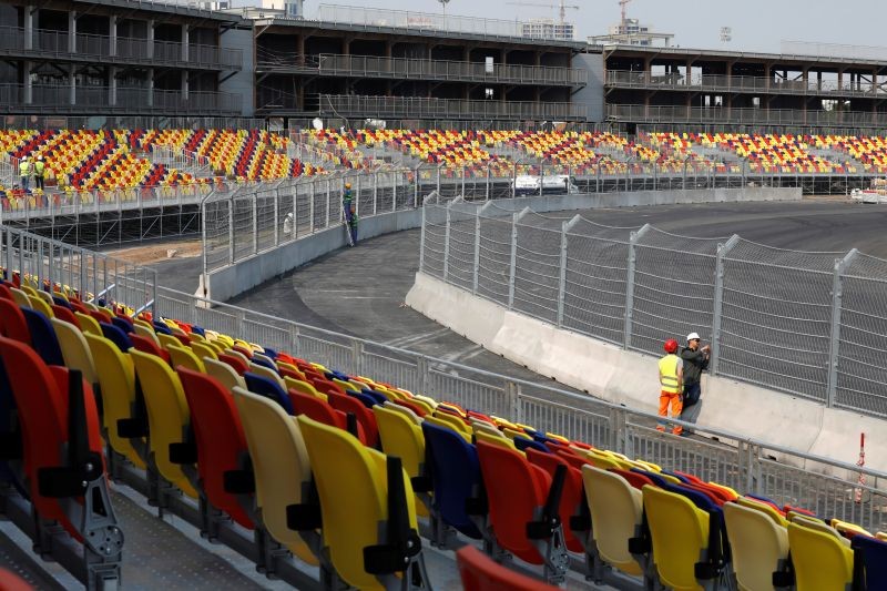 Labourers set up barriers on the track at the construction site of Formula One Vietnam Grand Prix race track in Hanoi, Vietnam February 18, 2020. REUTERS/Kham/Files