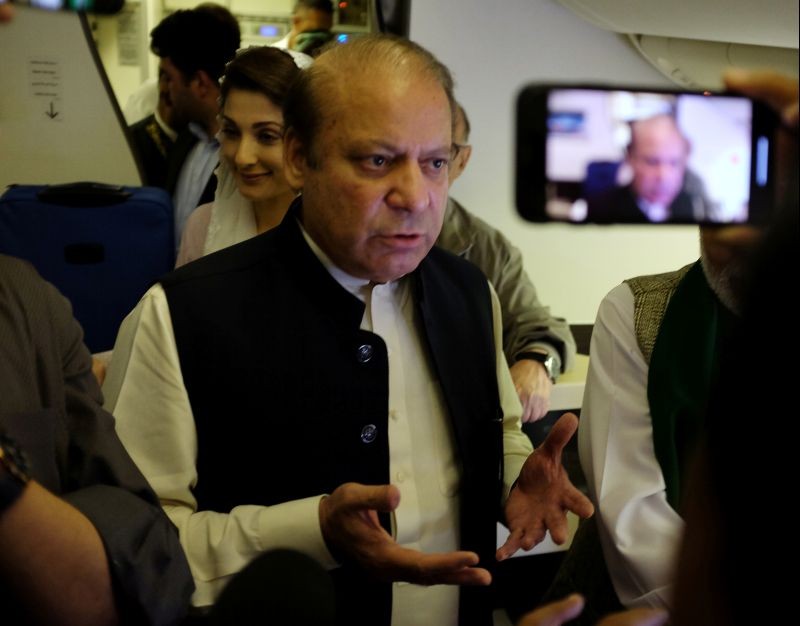 Ousted Pakistani Prime Minister Nawaz Sharif gestures as he boards a Lahore-bound flight due for departure, at Abu Dhabi International Airport, UAE on July 13, 2018. (REUTERS File Photo)