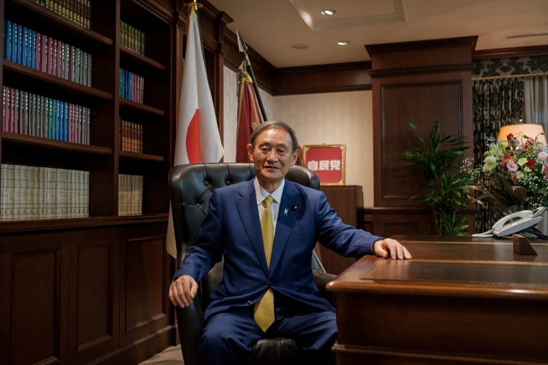 FILE PHOTO: Japanese Chief Cabinet Secretary Yoshihide Suga poses for a picture following a press conference at LDP (Liberal Democratic Party) headquarters, in Tokyo, Japan September 14, 2020. Nicolas Datiche/Pool via REUTERS/File Photo/File Photo