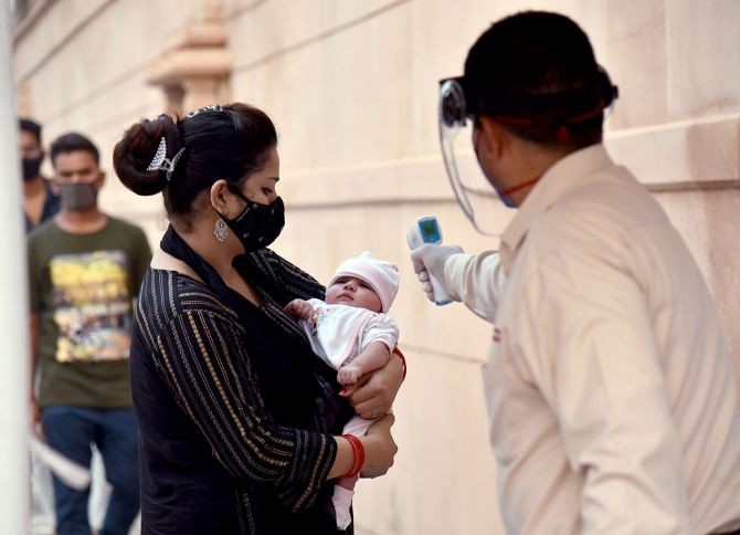 An infant being screened at Swaminarayan Akshardham Temple in New Delhi. Photograph: Rahul Singh/ANI Photo
