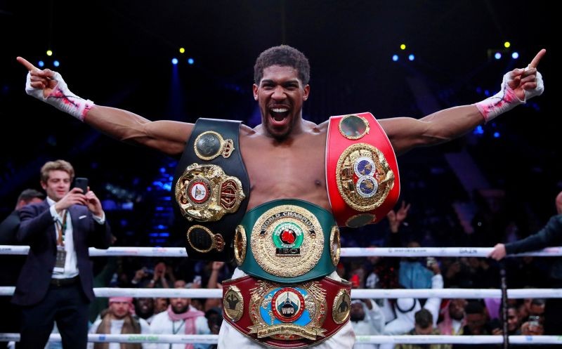 FILE PHOTO: Boxing - Anthony Joshua celebrates winning his fight against Andy Ruiz Jr. with the IBF, WBA, WBO & IBO World Heavyweight Belts - Diriyah Arena, Diriyah, Saudi Arabia - December 7, 2019 Action Images via Reuters/Andrew Couldridge