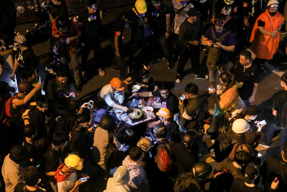 Protesters make hotpot in front of police headquarters during a rally in Bangkok, Thailand November 18, 2020. REUTERS/Soe Zeya Tun