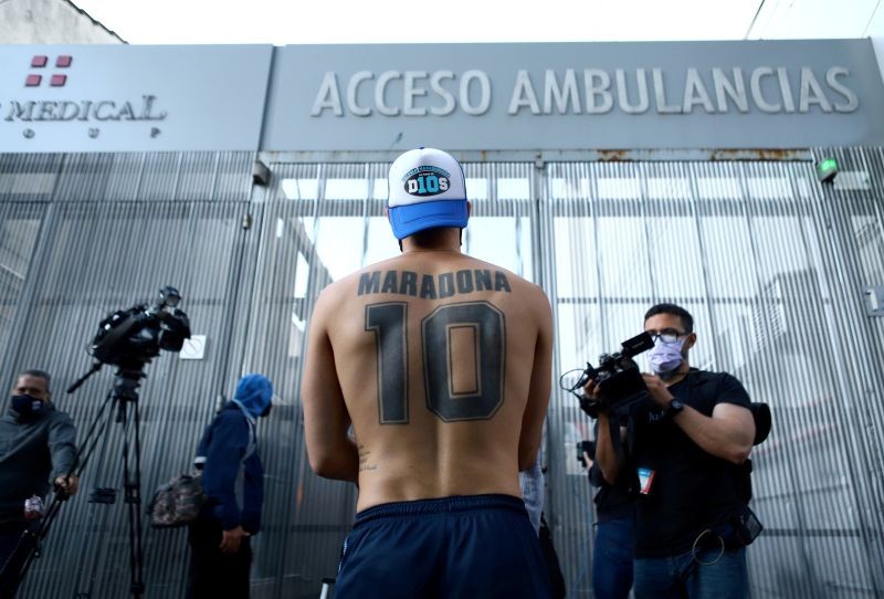 A fan of Argentine soccer great Diego Maradona stands outside the clinic where he will be undergoing surgery for a subdural haematoma, according to his personal physician, in Olivos, on the outskirts of Buenos Aires, Argentina November 3, 2020. REUTERS/Matias Baglietto