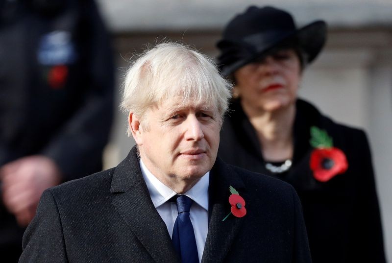 Britain's former Prime Minister Theresa May stands behind Prime Minister Boris Johnson during a National Service of Remembrance at the Cenotaph in Westminster, amid the spread of coronavirus (COVID-19) disease, London, Britain November 8, 2020. (REUTERS Photo)
