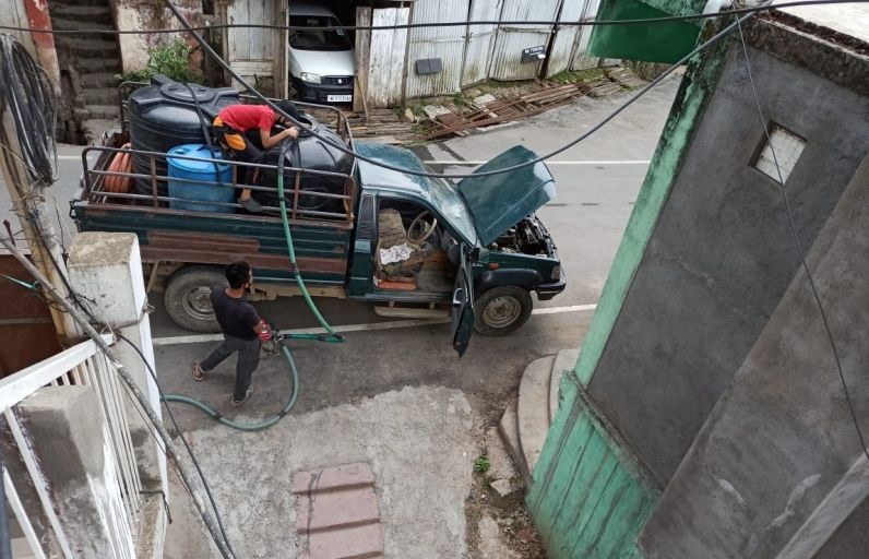 A private water carrier is seen distributing water to customers at a colony in Kohima. (Morung File Photo)