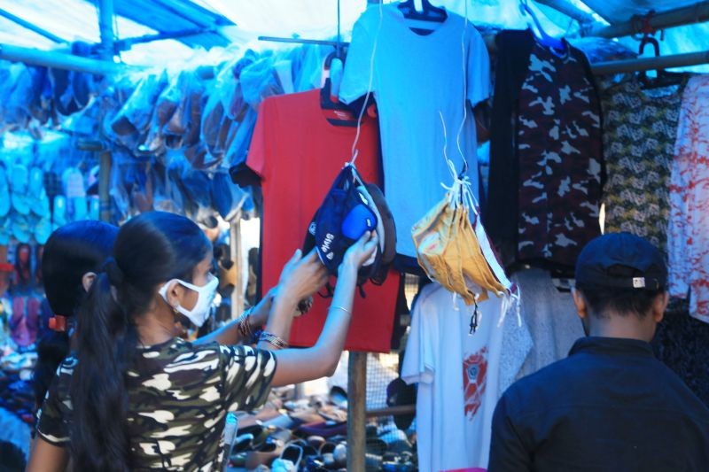 Shoppers examine fabric face masks on sale at a market in Dimapur.  (Morung File Photo by Soreishim Mahong)