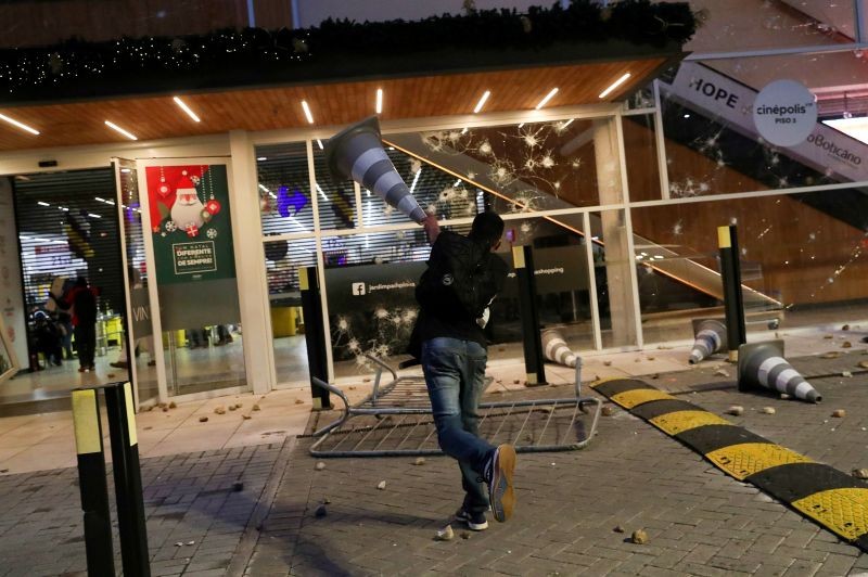 A demonstrator throws a cone towards a Carrefour store during a march in Sao Paulo on National Black Consciousness Day and in protest against the death of Joao Alberto Silveira Freitas, a Black man beaten to death at a market in Porto Alegre, Brazil, November 20, 2020. (REUTERS Photo)