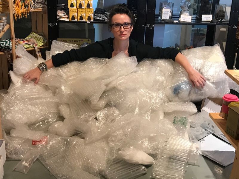 Claire Sancelot, the founder of The Hive Bulk Foods, a social enterprise in Malaysia that runs zero waste stores, poses with bubble wrap her firm collected for reuse due to a surge in plastic waste led by the increase in online deliveries over the pandemic. (REUTERS Photo)