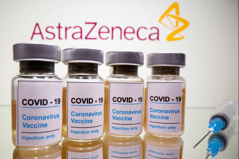 Vials with a sticker reading, "COVID-19 / Coronavirus vaccine / Injection only" and a medical syringe are seen in front of a displayed AstraZeneca logo in this illustration taken October 31, 2020. (REUTERS File Photo)