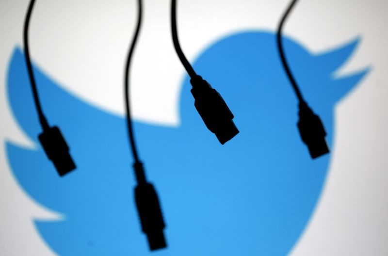 Electronic cables are silhouetted next to the logo of Twitter in this September 23, 2014 illustration photo in Sarajevo. (REUTER File Photo)