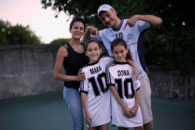 Walter Gaston Rotundo, a devoted Diego Maradona fan who named his twin daughters Mara and Dona after the soccer star, poses with his family in Buenos Aires, Argentina, November 27, 2020. REUTERS/Ueslei Marcelino