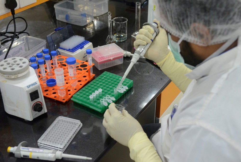 FILE PHOTO: A research scientist works inside a laboratory of India's Serum Institute, the world's largest maker of vaccines, which is working on vaccines against the coronavirus disease (COVID-19) in Pune, India, May 18, 2020. Picture taken May 18, 2020. REUTERS/Euan Rocha/File Photo