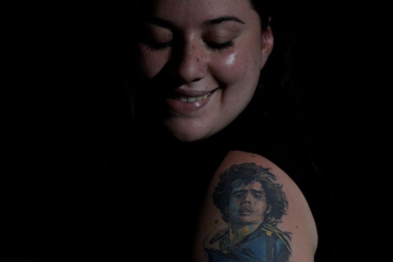 Nerea Barbosa, a devoted Diego Maradona fan who has images of Maradona tattooed on her arm, poses for a photo at her home in Buenos Aries, Argentina, November 29, 2020. "It is love, it is my great love, my passion to have Diego (on my body) so he is always with me everywhere. I feel like he protects me," said Barbosa. "When I got the tattoo, many told me no, that it was not for a woman and a tattoo like that was so grotesque," she said, adding that she felt both a feminist and a "Maradonian". "I say he was an idol for women too." REUTERS/Ueslei Marcelino