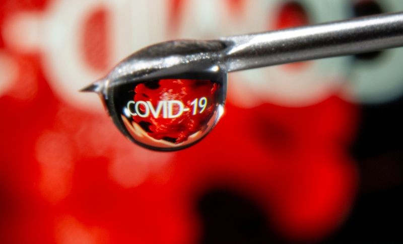 The word "COVID-19" is reflected in a drop on a syringe needle in this illustration taken November 9, 2020. (REUTERS File Photo)