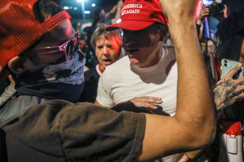 Supporters of U.S. President Donald Trump and counter-protesters yell at each other during a protest about the early results of the 2020 presidential election, in front of the Maricopa County Tabulation and Election Center (MCTEC), in Phoenix, Arizona, U.S., November 5, 2020. REUTERS/Jim Urquhart