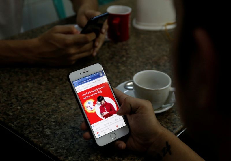 A cellphone user looks at a Facebook page at a shop in Latha street, Yangon, Myanmar August 8, 2018. (REUTERS File Photo)