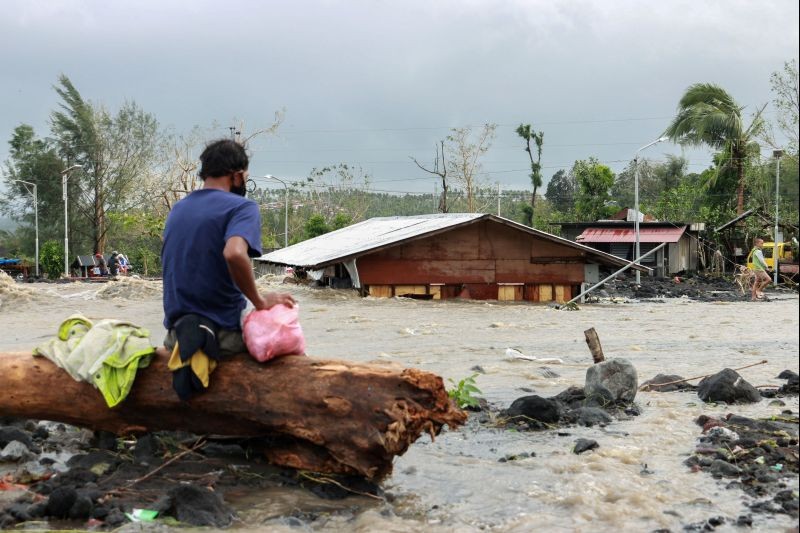 A man looks at his house buried under the pile of rubble and sand following flash floods brought by Typhoon 'Goni' in Barangay Busay, Daraga town, Albay province, Philippines, November 1, 2020. (REUTERS Photo)