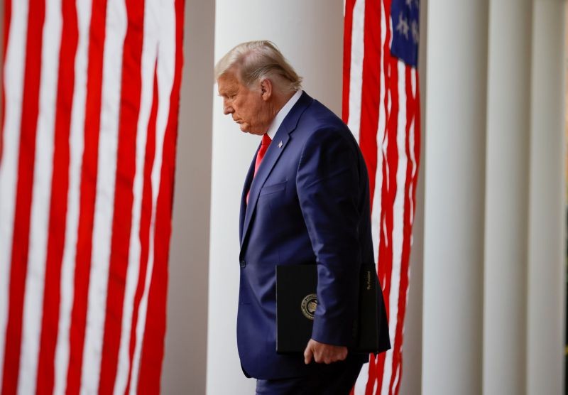 FILE PHOTO: U.S. President Donald Trump walks down the West Wing colonnade from the Oval Office to the Rose Garden to deliver an update on the so-called "Operation Warp Speed" program, the joint Defense Department and HHS initiative that has struck deals with several drugmakers in an effort to help speed up the search for effective treatments for the ongoing coronavirus disease (COVID-19) pandemic, at the White House in Washington, U.S., November 13, 2020. REUTERS/Carlos Barria/File Photo