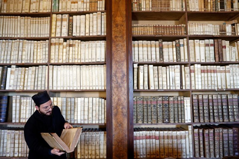 Brother Claudio, 27, reads a book at Greek Abbey of Saint Nilus, which hosts Italy's last ten Basilian monks of the Greek rite, in Grottaferrata, Italy, November 24, 2020. (REUTERS File Photo)