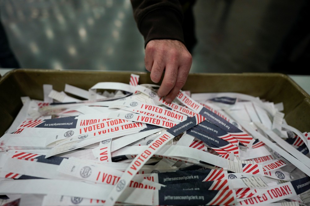 A voter takes a "I voted today" badge at the Kentucky Exposition Center during the election in Louisville, Kentucky, U.S. November 3, 2020. REUTERS/Bryan Woolston