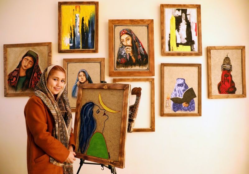 Afghan artist Faiqa Sultani poses next to her painting at the Namad Gallery in Kabul, Afghanistan November 9, 2020. (REUTERS File Photo)