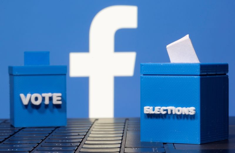 3D printed ballot boxes are seen in front of a displayed Facebook logo in this illustration taken November 4, 2020. (REUTERS File Photo)