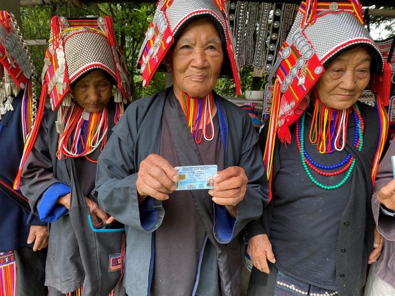 Ethnic Akha women, once regarded as stateless, holding their Thai citizenship identity cards in Chiang Rai province in northern Thailand. August 31, 2020. (Thomson Reuters Foundation File Photo)