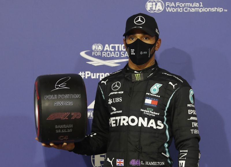 Formula One F1 - Bahrain Grand Prix - Bahrain International Circuit, Sakhir, Bahrain - November 28, 2020 Mercedes' Lewis Hamilton celebrates with an award after qualifying in pole position Pool via REUTERS/Hamad I Mohammed