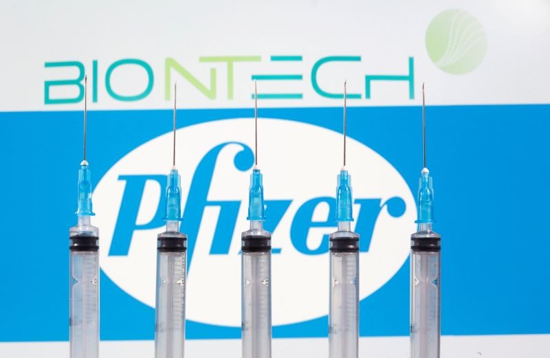 Syringes are seen in front of displayed Biontech and Pfizer logos in this illustration taken November 10, 2020. (REUTERS File Photo)