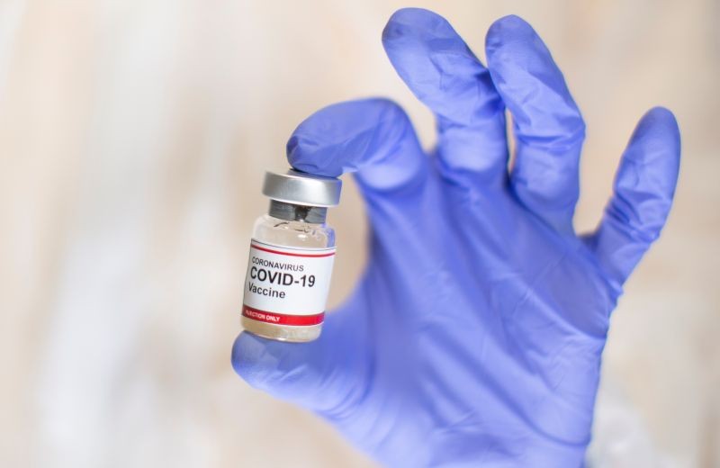 A woman holds a small bottle labeled with a "Coronavirus COVID-19 Vaccine" sticker  in this illustration taken, October 30, 2020. (REUTERS File Photo)